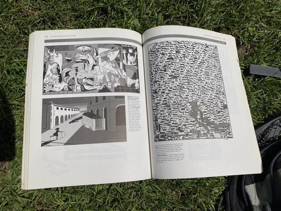 A page from the book, showing two pixel art intepretations of famous paintings: The Guernica and Melancholy and Mystery of a Street.